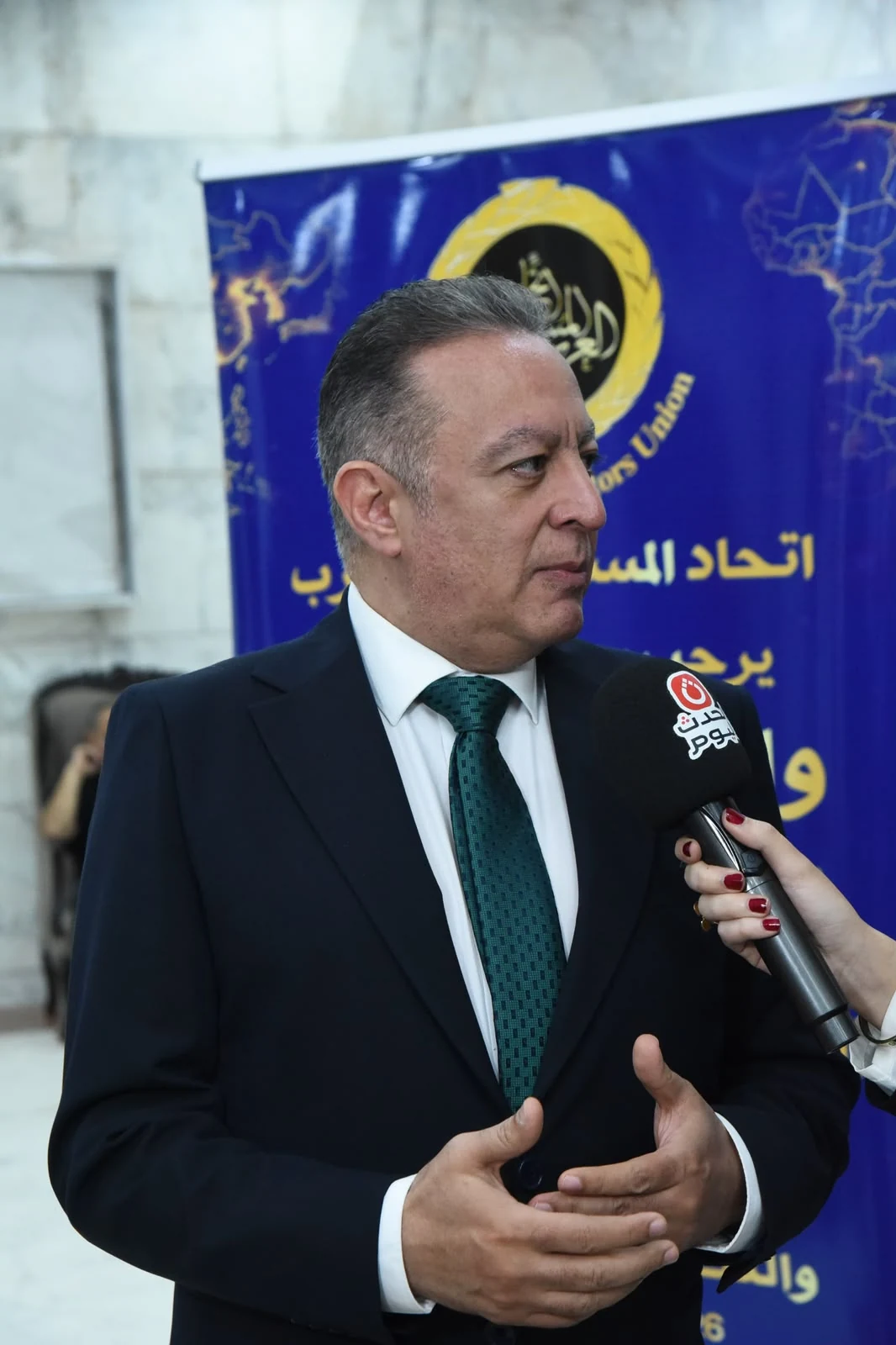 Prof. Dr. Ayman Diab speaking during a televised press interview at the Arab-African Investment Summit